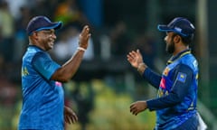 Sanath Jayasuriya (left) and his captain, Charith Asalanka, celebrate after winning the third and final ODI against India.