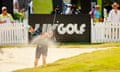 a golfer chips his ball out of the bunker