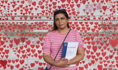 Petra Fleming in front of Covid wall of remembrance with red hearts