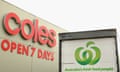 Coles sign next to a truck with Woolworths branding