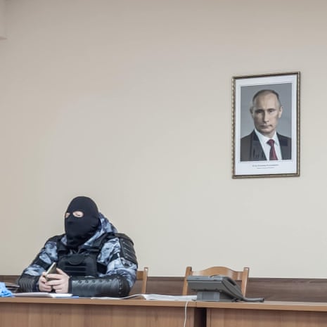 Markov’s shot of a police officer, taken after he participated in an opposition protest. 