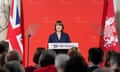 Rachel Reeves in front of a red backdrop with the Treasury logo