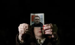 A protester holding a photo of late Russian opposition leader Alexei Navalny attends a rally to commemorate his death