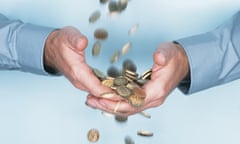 Man cupping hands under stream of falling one pound coins.