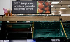 Empty shelves of fresh tomatoes are seen in a Tesco supermarket in London.