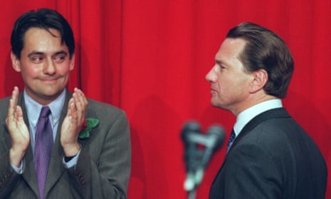 Stephen Twigg looks over towards Michael Portillo while clapping; Portillo, seen in profile on the right of the picture, has an unreadable expression