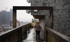 The back of a woman on an upper floor balcony