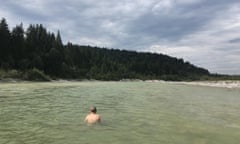 Rear View Of Man Swimming In Lake Against Cloudy Sky<br>WCB3A1 Rear View Of Man Swimming In Lake Against Cloudy Sky