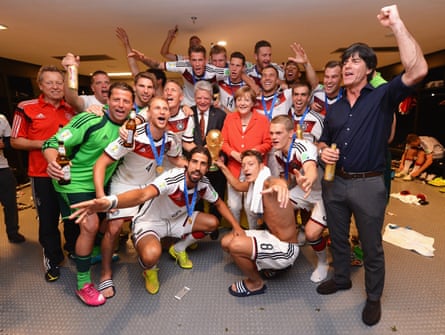 Joachim Löw and his players celebrate with the World Cup in 2014 alongside German chancellor Angela Merkel and president Joachim Gauck.