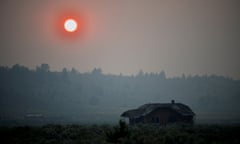 Firefighters deal with extreme conditions as Bootleg Fire expands, in Oregon<br>Thick smoke causes the sun to glow red over an abandoned farmhouse as the Bootleg Fire expands to over 200,000 acres, near Beatty, Oregon, U.S., July 13, 2021. Picture taken July 13, 2021. REUTERS/Mathieu Lewis-Rolland