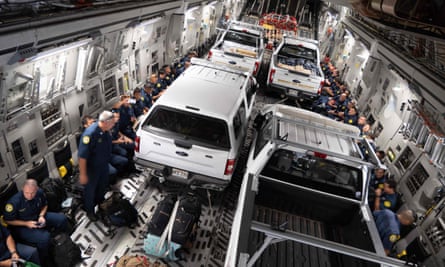 Honolulu fire department vehicles and personnel are secured onto a C-17 Globemaster III at Joint Base Pearl Harbor-Hickam in Honolulu, Hawaii.