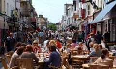 Visitors enjoy dining outside alfresco style in the North Laine area of Brighton UK June 2007