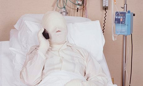 bandaged man in hospital bed