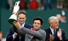 Rory McIlroy holding the British Open trophy 