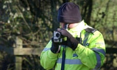 A police officer with video camera monitors hunt protesters