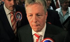 Northern Ireland's first minister, Peter Robinson, reacts after losing his Belfast East seat