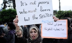 A Moroccan woman holds a sign in support of the opposition February 20 movement