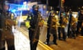 Police officers form a barricade during during demonstrations in Stokes Croft, Bristol