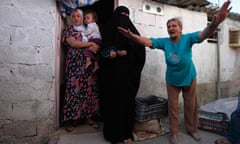 A woman complains about living conditions at her home in a shantytown in Algeria