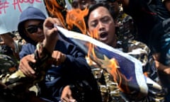 Indonesian activists burn the Australian flag during a rally in front of the Australian embassy on 21 November.