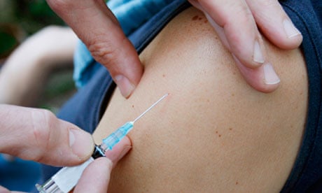 Doctor takes needle out of arm after injection. Image shot 2007. Exact date unknown.