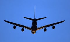 An aeroplane comes in to land at Heathrow airport at sunset