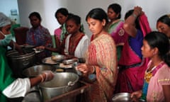 Women who had sterilisation surgery queue with their children for food inside a hospital in Bilaspur district in the Indian state of Chhattisgarh.