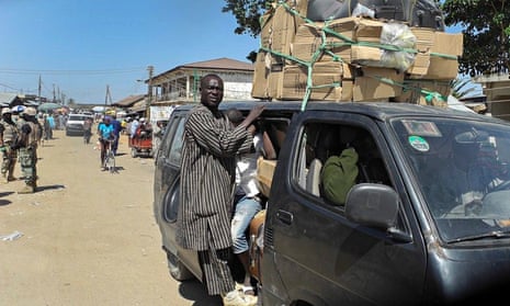 Nigerians cram into a bus to flee a town in north-east Nigeria following Boko Haram attack on Baga