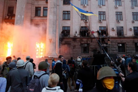 People wait to be rescued from the upper storeys of the Trade Union building in Odessa.