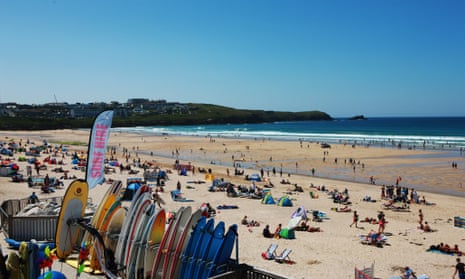 People enjoying the sun at Fistral Beach on June 30, 2015 in Newquay, England.