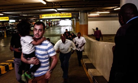 People leaving the Westgate shopping mall in Nairobi after an attack by gunmen