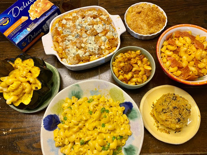 Seven different bowls of macaroni and cheese.