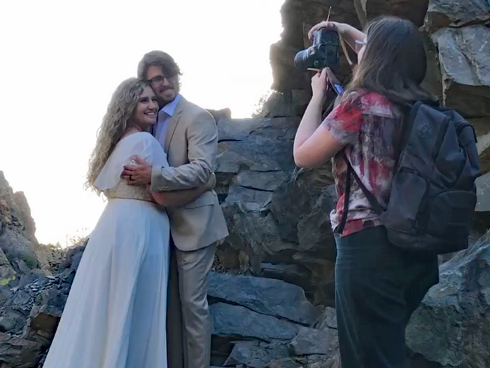 cameron dever taking a photo of a couple on their wedding day