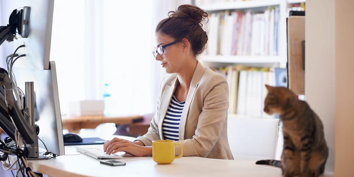 woman at home working desktop computer typing