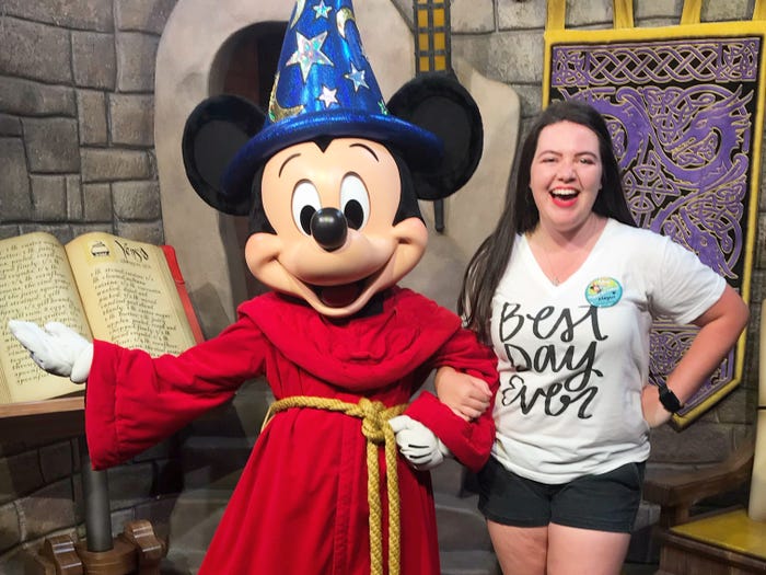 megan dubois posing with sorcerer mickey in disney world