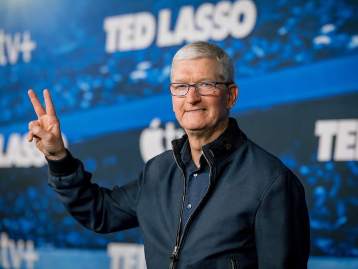 Tim Cook doing a 'peace' sign with his fingers while attending the Apple Original series 'Ted Lasso' Season 3 red carpet premiere event.