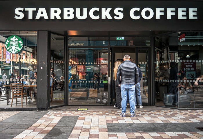 Starbucks customers wait in line.