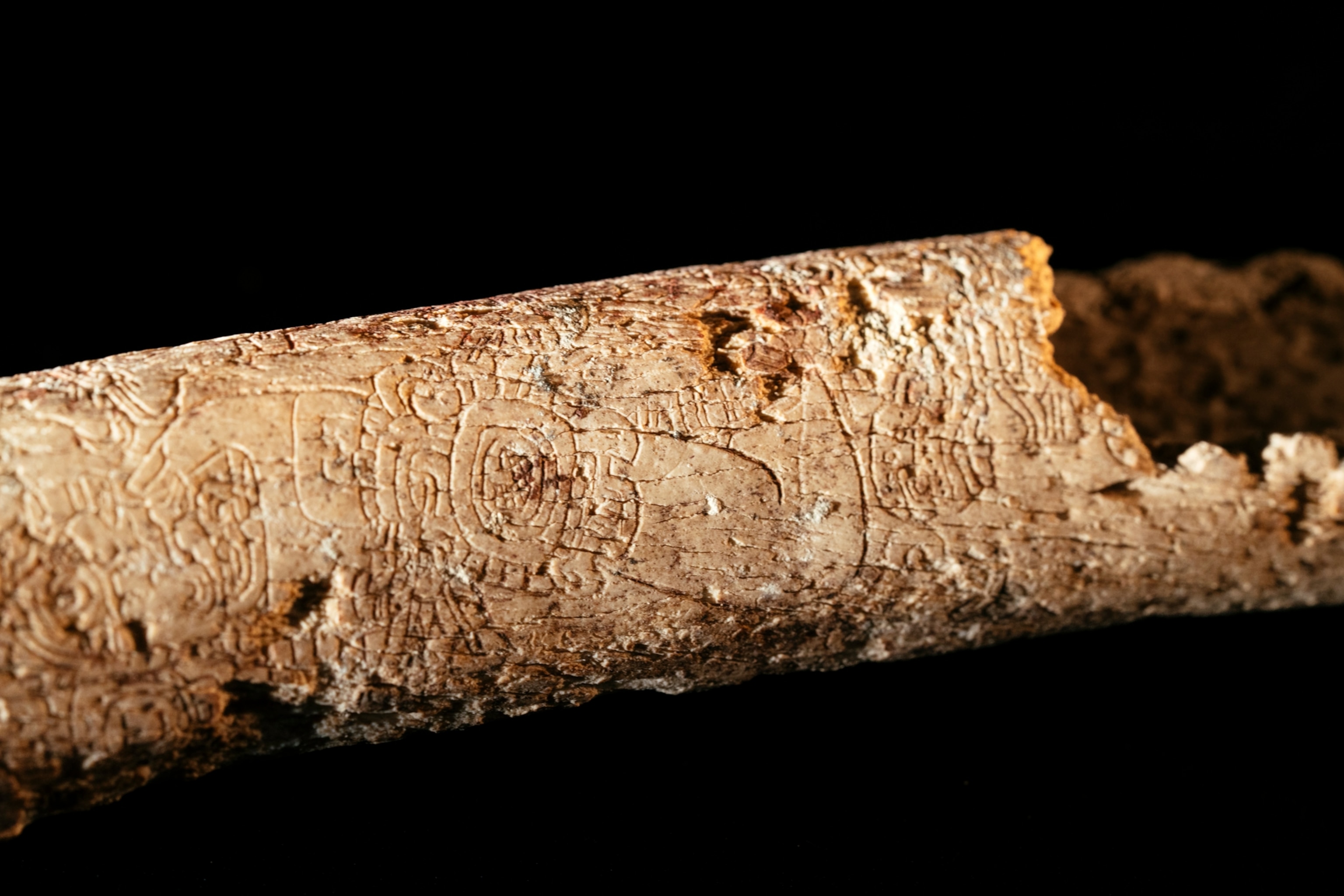 Carved human bone found at a Mayan burial