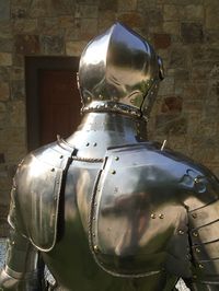 Medieval suits of armor were created in order to protect the knights during battle and make them more efficient warriors. There were three types of fighting men during the middle ages known as Knights, Foot Soldiers, and Archers. Suit of armor usually consists of the helmet breastplate & backplate, gauntlets, pauldrons (or shoulders), vambraces, couters, sabatons (foot armor), greaves (to protect shins). Crusader Helmet Has small slits for eyes and breathing/ventilation which may be decorative a