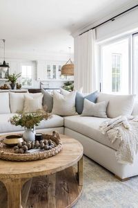 Love this beautiful modern living room with a large sectional, round wood coffee table, and neutral furniture and decor - living room furniture - living room decor - living room table - coastal living room - coastal decor - modern coastal style - pure salt interiors