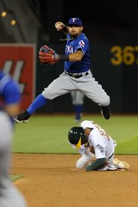 Rougned Odor #12 of the Texas Rangers attempts to turn a double play as Marcus Semien #10 of the Oakland Athletics slides in to second base at O.co Coliseum on June 13, 2016 in Oakland, California. (Photo by Robert Reiners/Getty Images)