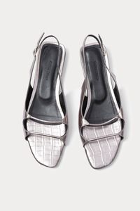 Slingback sandals with low block heel and two delicate straps across the forefoot, in metallic croc print leather. 100% Leather Upper and Sole 15mm heel Rubber heel cap Spaghetti straps at vamp Silver nickel buckle Made in Peru
