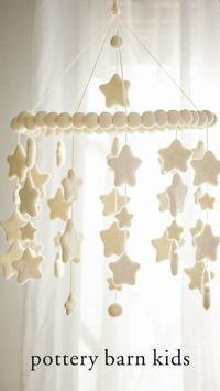 This nursery mobile will put a twinkle in their eye with a constellation of ivory stars. Plush, soft and fun to touch, the stars are crafted of soft wool felt and strung from a canopy of plush wool spheres.