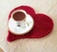 I knitted a small placemat for my coffee break in the shape of a heart. The heart was knitted sideways and in the end I crocheted a backs...