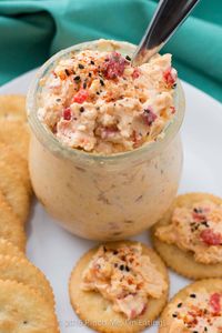 With ample seasonings and just a little kick, creamy Southern pimento cheese is great with everything from crackers or burgers to crab cakes or grits! This cheddar cheese spread also makes a great cold party appetizer dip that doesn't require the oven.