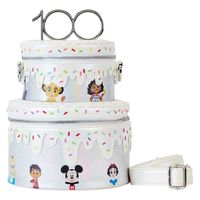 A confectionary wonder takes shape as this three-dimensional bag forms a tiered anniversary cake. Sprinkled icing covers the cake’s layers, which unzip to store your essentials. Turn the bag around to see exclusive artwork of fan-favorite Disney and Disney-Pixar characters as they join the fun! Up above, a 100-year cake topper doubles as the bag’s handle. This bag is an officially licensed Disney product. Dimensions: 7”W x 7.5”H x 7”D Material: Faux leather (polyurethane) Features: Bag has adjus