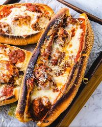 If you live in New York you call it a meatball parm hero. In other parts of the country it's a meatball sub, grinder or hoagie. I just call it delicious! There is simply nothing better than Italian meatballs in sauce with melted mozzarella and parmesan cheese on crusty Italian bread. #meatballhero #meatballsub #meatballparm #meatballparmigiana #meatballparmesan
