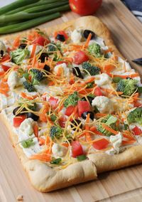 Veggie Pizza is an easy appetizer for potlucks, tailgate parties, showers, and picnics – using crescent rolls and your favorite veggies! Crescent Roll Veggie Pizza is a classic appetizer that’s a hit at every party! You know you’ve had it before—that crescent roll crust, a creamy topping, and fresh vegetables and cheddar cheese on top. (Don’t forget the black olives!)