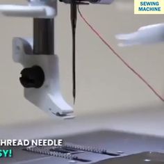 someone is working on a sewing machine with the needle being pulled away from the machine