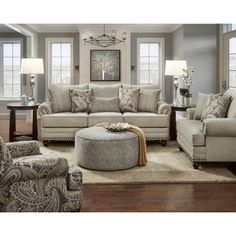 a couch and ottoman in a living room with the caption ever hart sofa shop now